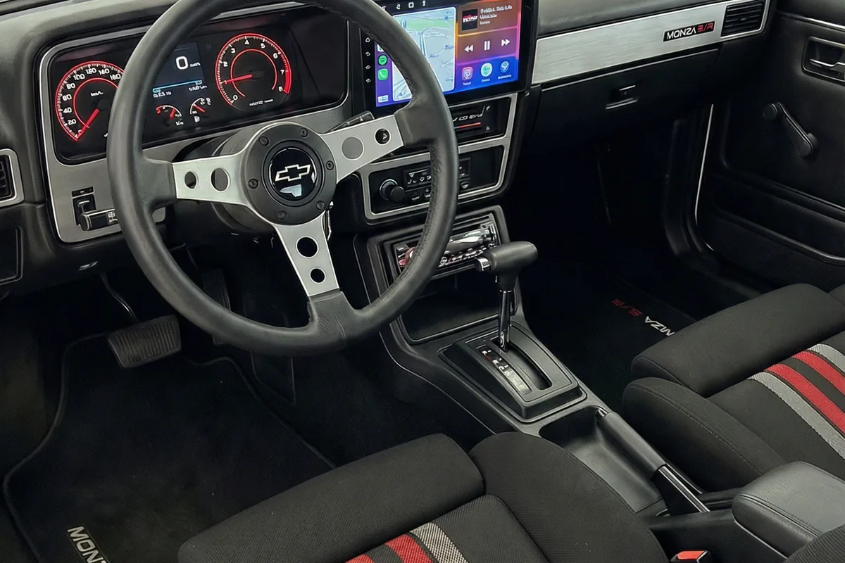 Interior do Monza SR Concept. Painel clássico com cluster digital, tela multimídia, volante retrô e bancos esportivos.