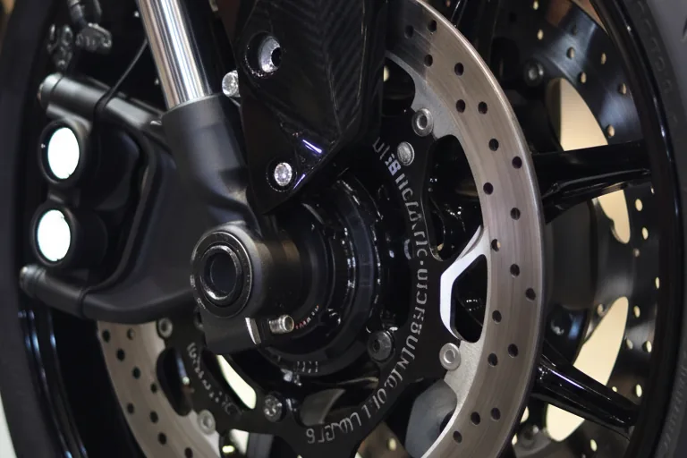 Close-up do disco de freio dianteiro, pinça e cubo da roda preta da Yamaha XJ6 X