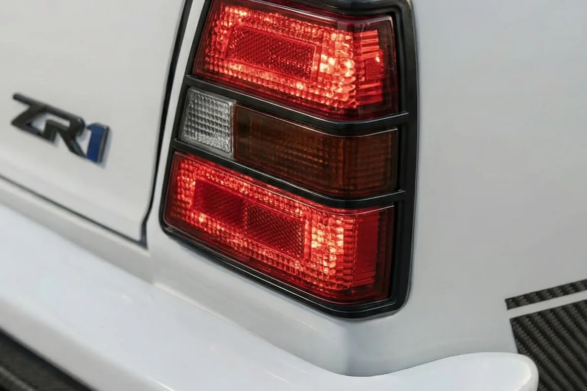 Lanterna traseira tricolor original da Caravan, com emblema ZR1 azul na lataria branca ao lado.