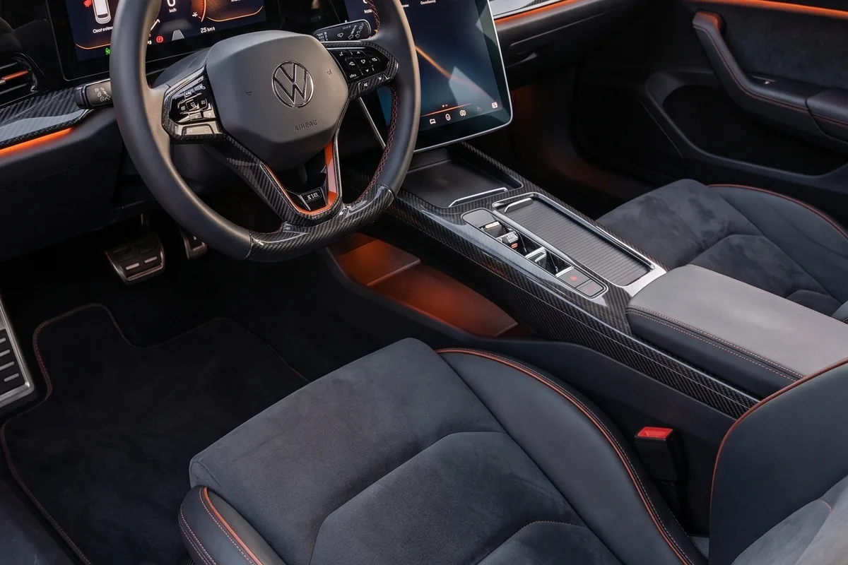 Interior do VW SP2 EV com volante de carbono, bancos em Alcântara cinza com costura laranja e painel digital